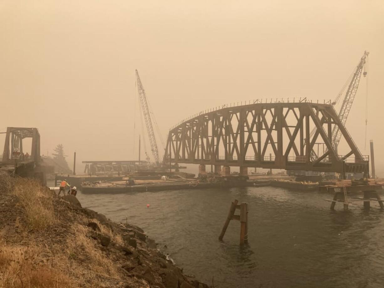 A photo taken last week shows the new BNSF Railway bridge at Drano Lake positioned on a barge awaiting installation. On Sunday morning, crews removed the old bridge and used the barge to slide the new one into place.