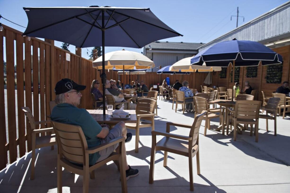 Phillip Thorgrimsen of Vancouver relaxes in the shade in the outdoor seating area at Billy Blues Bar &amp; Grill. The restaurant&#039;s outdoor seating, like most in Vancouver, heavily contributes to keeping it alive. But once foul weather rolls in, it will go away, along with seating opportunities.