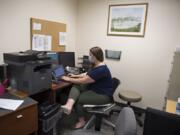 Medical student Megan Short works with a patient while communicating via smartphone during a telemedicine clinic at the Vancouver-based Free Clinic of Southwest Washington in August. The clinic brought back in-person appointments this month.