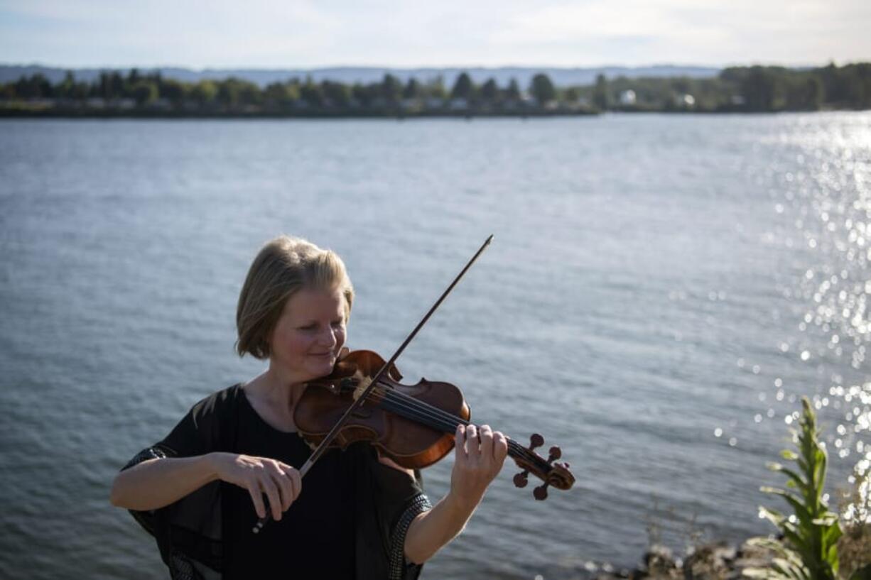 The Vancouver Symphony Orchestra&#039;s upcoming online concert will feature a reduced group of musicians -- mostly string players such as concertmaster Eva Richey, pictured here at the Vancouver waterfront on a recent evening. No breath-powered instruments will be part of the concert because of the risk of coronavirus transmission.