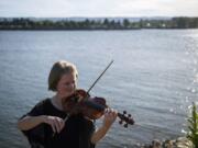 The Vancouver Symphony Orchestra&#039;s upcoming online concert will feature a reduced group of musicians -- mostly string players such as concertmaster Eva Richey, pictured here at the Vancouver waterfront on a recent evening. No breath-powered instruments will be part of the concert because of the risk of coronavirus transmission.