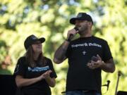 Michelle Dawson of Battle Ground, left, and Patriot Prayer leader Joey Gibson speak Saturday in Vancouver&#039;s Esther Short Park during the memorial to remember Aaron &quot;Jay&quot; Danielson who was fatally shot after a pro-Trump rally in Portland last month.