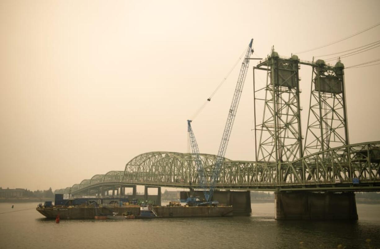 The northbound span of the Interstate 5 Bridge will close to all traffic for nine days beginning Saturday. All freeway traffic will use the southbound span while crews work to replace a cracked trunnion and other parts of the northbound bridge&#039;s lift system. At top: Crews will use a barge-mounted crane to lift down the worn-out components of the lift system and replace them with new parts.