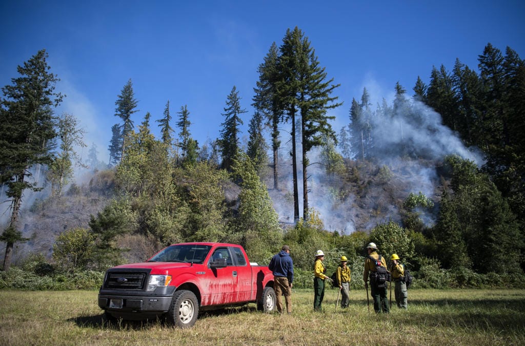 Fire crews work the Washougal River Road fire just past mile marker 5 Tuesday morning outside of Washougal. As of Tuesday morning, the fire, likely caused by a power line, was about 10 acres and 20 percent contained.