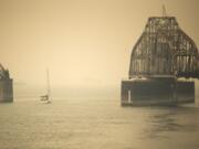 A sailboat makes its way past the railroad bridge Thursday. Clark County air quality is approaching the designation of hazardous, the worst level of air quality, according to the Washington Department of Ecology. Air quality is expected to worsen Friday and continue to be poor throughout the weekend.