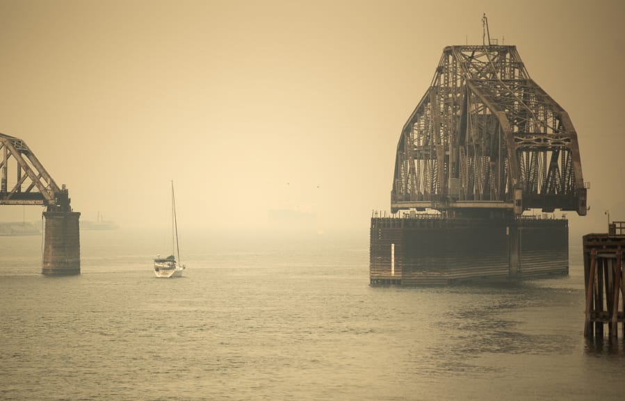 A sailboat makes its way past the railroad bridge Thursday. Clark County air quality is approaching the designation of hazardous, the worst level of air quality, according to the Washington Department of Ecology. Air quality is expected to worsen Friday and continue to be poor throughout the weekend.