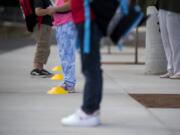 Students and teachers keep their distance as they prepare to enter the building at Sifton Elementary School on Tuesday afternoon, Sept. 22, 2020.