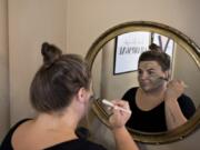 Salon manager Alex James demonstrates an Epicuren green tea and seaweed smoothing mask at Glam Beauty Bar in downtown Vancouver. James and other spa staff normally wear masks while in the salon.