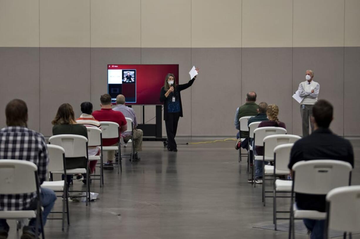 Clark County jury coordinator Gigi Darfler, center, gives instructions to potential jurors as they begin jury selection for a civil trial Monday morning at the Clark County Event Center at the Fairgrounds. The Superior Court trial is one of two that commenced Monday. They are the first to be heard by jurors since mid-March due to COVID-19. Jury selection for a Clark County District Court domestic violence case was carried out at the courthouse in Vancouver.