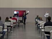 Clark County jury coordinator Gigi Darfler, center, gives instructions to potential jurors as they begin jury selection for a civil trial Monday morning at the Clark County Event Center at the Fairgrounds. The Superior Court trial is one of two that commenced Monday. They are the first to be heard by jurors since mid-March due to COVID-19. Jury selection for a Clark County District Court domestic violence case was carried out at the courthouse in Vancouver.