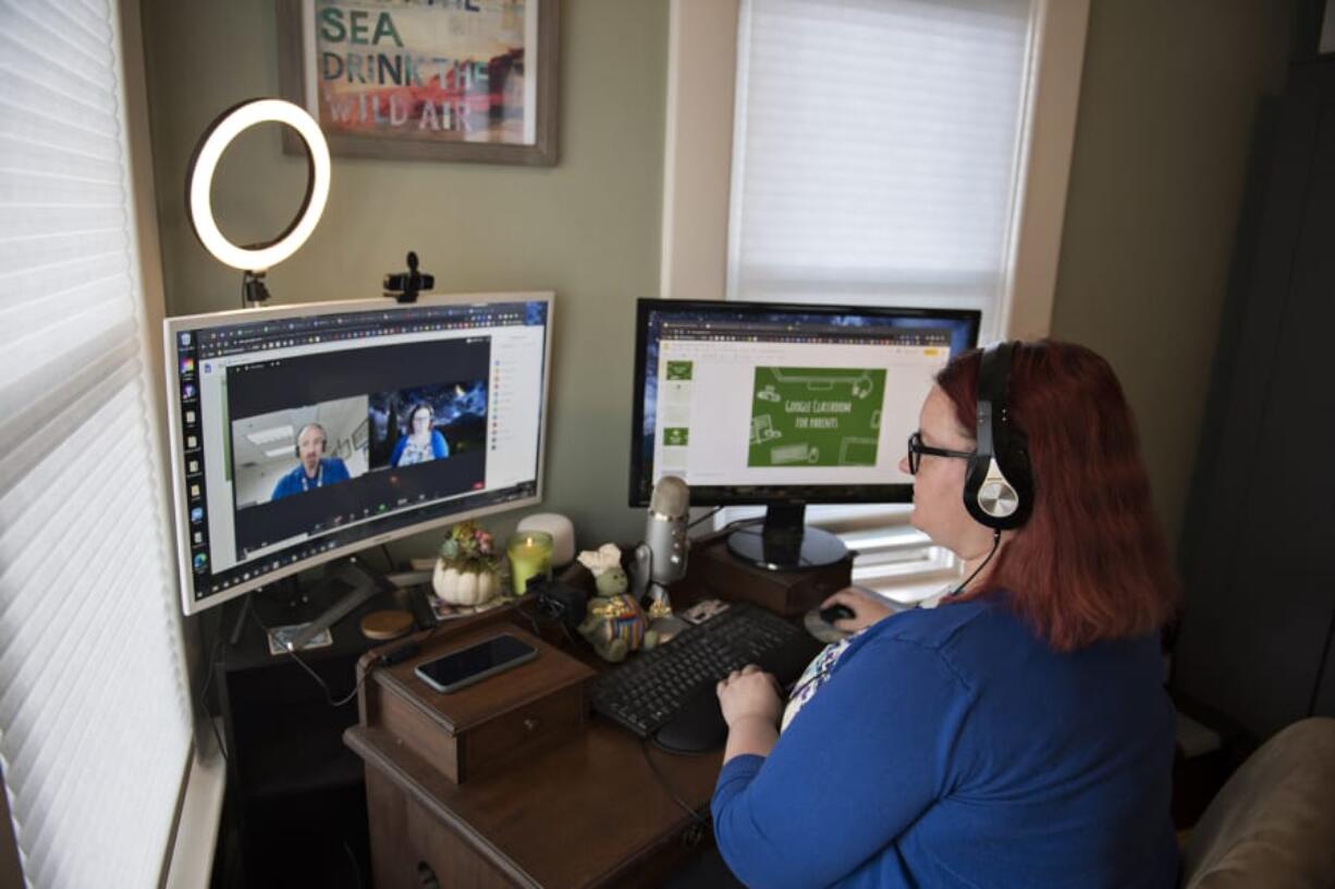 Technology director Scott McDaniel, left, on screen, talks with Cassondra Smith, Battle Ground Public Schools educational technology coordinator, as they prepare to lead local parents through using the Google Classroom program Thursday afternoon. Battle Ground Public Schools launched the Parent Academy this school year, offering families an opportunity to take classes on the programs their students use in class.