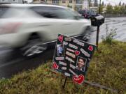 Motorists drive past a small memorial for two boys who died in January, as seen near the intersection Northeast 23rd Street and Northeast 112th Avenue. The kids -- Taylor Crepeau, 14, and Andrew Friedt, 17 -- were hit by a car while trying to cross Northeast 112th Avenue.