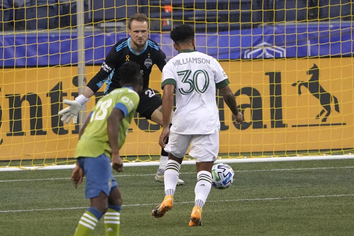 Portland Timbers midfielder Eryk Williamson (30) sets up to kick a goal against Seattle Sounders goalkeeper Stefan Frei, center, during the first half of an MLS soccer match, Sunday, Sept. 6, 2020, in Seattle. (AP Photo/Ted S.