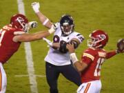 Kansas City Chiefs quarterback Patrick Mahomes (15) passes as he is pressured by Houston Texans defensive end J.J. Watt (99) in the first half of an NFL football game Thursday, Sept. 10, 2020, in Kansas City, Mo.