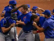 Chicago Cubs starting pitcher Alec Mills is swarmed by teammates after throwing a no hitter at a baseball game against the Milwaukee Brewers Sunday, Sept. 13, 2020, in Milwaukee. The Cubs won 12-0.