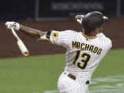 San Diego Padres' Manny Machado hits a solo home run during the ninth inning of the team's baseball game against the Seattle Mariners on Friday, Sept. 18, 2020, in San Diego.