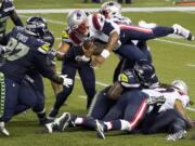 New England Patriots quarterback Cam Newton dives with the ball but is stopped near the goal line as the clock expires in the fourth quarter of an NFL football game against the Seattle Seahawks, Sunday, Sept. 20, 2020, in Seattle. The Seahawks won 35-30.