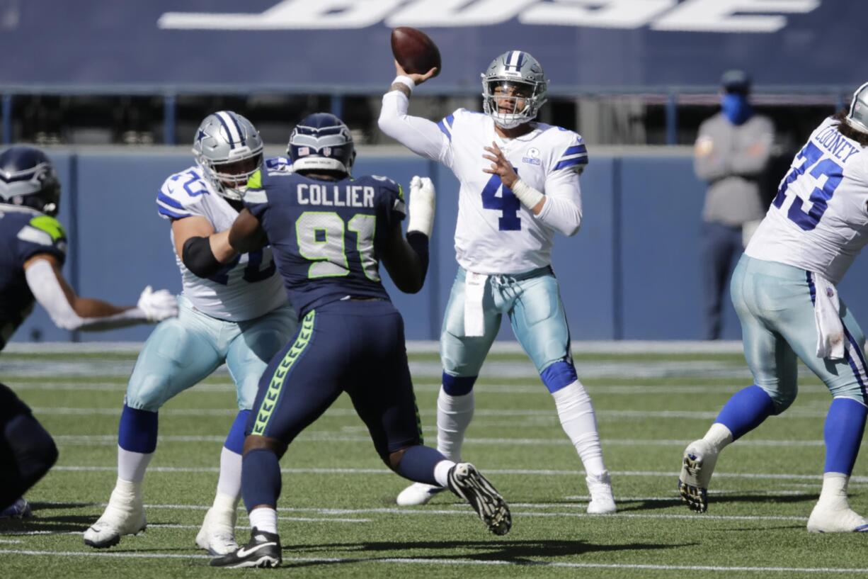 Dallas Cowboys quarterback Dak Prescott passes as Seattle Seahawks defensive end L.J. Collier blocks during the first half of an NFL football game, Sunday, Sept. 27, 2020, in Seattle.