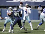 Dallas Cowboys quarterback Dak Prescott passes as Seattle Seahawks defensive end L.J. Collier blocks during the first half of an NFL football game, Sunday, Sept. 27, 2020, in Seattle.