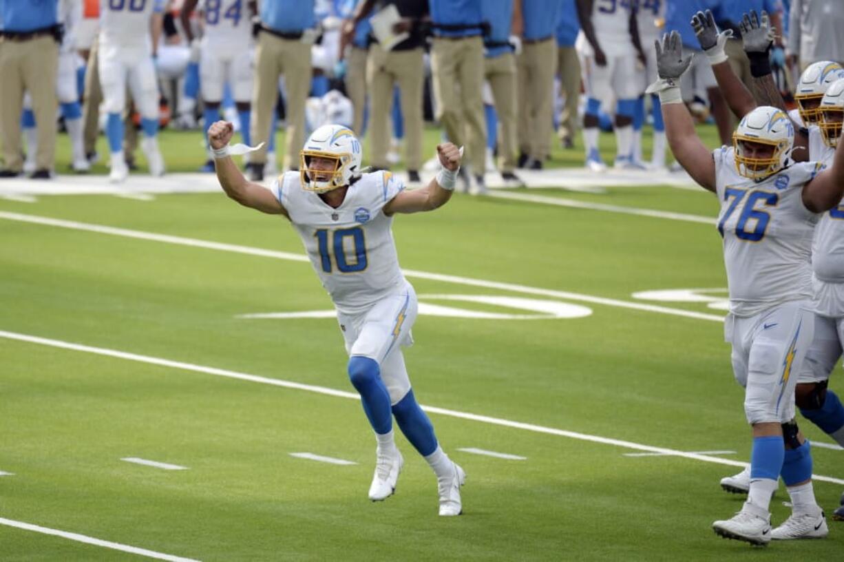 Los Angeles Chargers quarterback Justin Herbert celebrates after throwing his first career touchdown pass during the first half of an NFL football game against the Kansas City Chiefs Sunday, Sept. 20, 2020, in Inglewood, Calif.