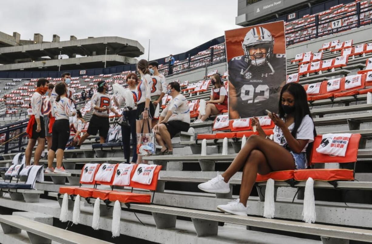 Auburn students are socially distanced as they wait for the start of an NCAA college football game against Kentucky on Saturday in Auburn, Ala.