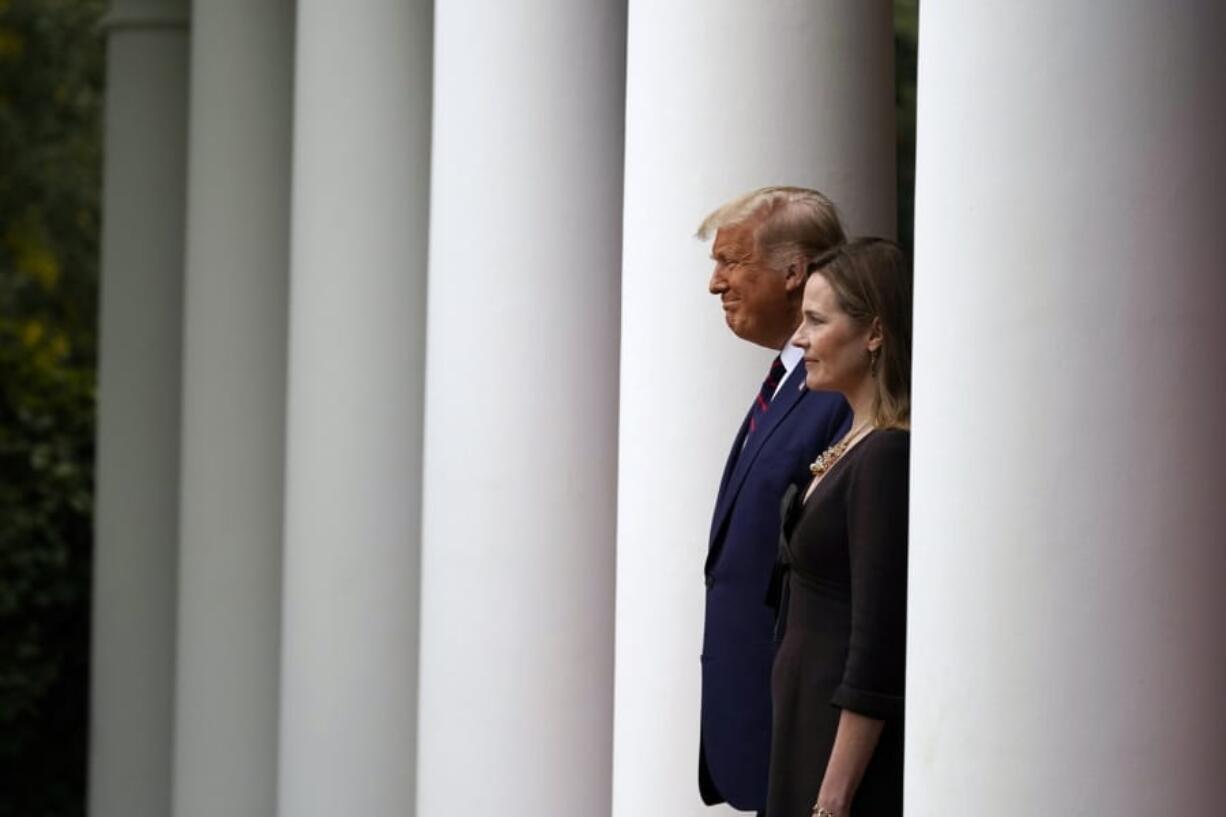 President Donald Trump walks with Judge Amy Coney Barrett to a news conference to announce Barrett as his nominee to the Supreme Court, in the Rose Garden at the White House, Saturday, Sept. 26, 2020, in Washington.