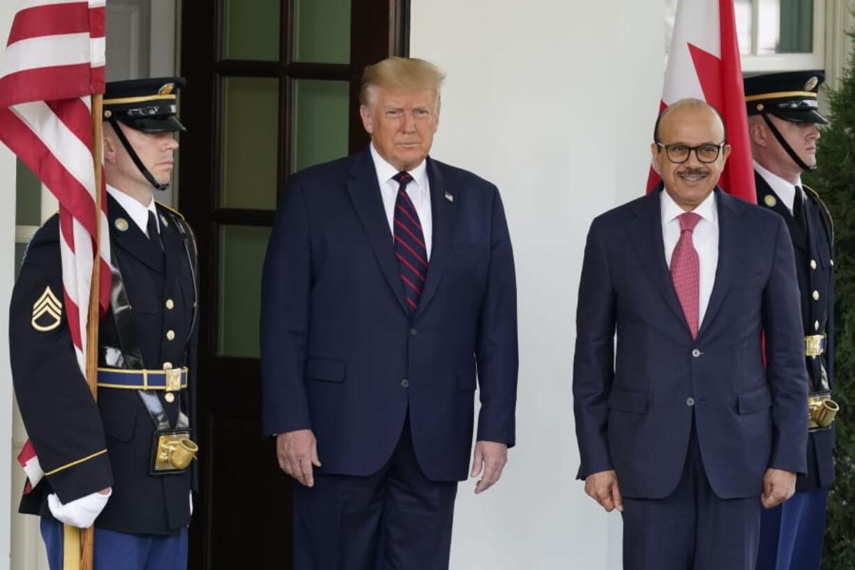 President Donald Trump greets the Bahrain Foreign Minister Khalid bin Ahmed Al Khalifa at the White House, Tuesday, Sept. 15, 2020, in Washington.