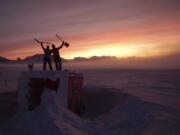 In this handout photo provided by British Antarctic Survey, field guides Sarah Crowsley, left, and Sam Hunt, right, pose for a photo after digging out the caboose, a container used for accommodation that can be moved by a tractor, at Adelaide island, in Antarctica on Friday, June 19, 2020. Antarctica remains the only continent without COVID-19 and now in Sept. 2020, as nearly 1,000 scientists and others who wintered over on the ice are seeing the sun for the first time in months, a global effort wants to make sure incoming colleagues don&#039;t bring the virus with them.