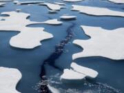 FILE - Sea ice breaks apart as the Finnish icebreaker MSV Nordica traverses the Northwest Passage through the Victoria Strait in the Canadian Arctic Archipelago in a Friday, July 21, 2017 file photo.  The National Snow and Ice Data Center&#039;s figures Monday, Sept. 21, 2020 show that sea ice last week was only 1.4 million square miles when it reached its annual low mark for the summer. In the 1980s it was always at least 1 million square miles more.