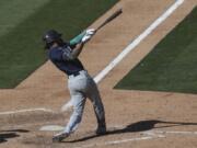 Seattle Mariners&#039; J.P. Crawford hits an RBI-single against the Oakland Athletics during the eighth inning of the first baseball game of a doubleheader in Oakland, Calif., Saturday, Sept. 26, 2020.