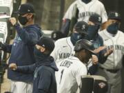 Seattle Mariners&#039; Kyle Lewis (1) is greeted in the dugout after he hit a two-run home run against the Oakland Athletics during the fifth inning of the first baseball game of a doubleheader, Monday, Sept. 14, 2020, in Seattle. (AP Photo/Ted S.