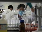 An employee of SinoVac works in a lab at a factory producing its SARS CoV-2 Vaccine for COVID-19 named CoronaVac in Beijing on Thursday, Sept. 24, 2020. SinoVac&#039;s CEO says they have injected 90 percent of its employees and family members, or about 3,000 people, and provided tens of thousands of rounds of CoronaVac to the municipal government of Beijing. It&#039;s a highly unusual move that raises ethical and safety questions, as companies and governments worldwide race to develop a vaccine that will stop the spread of the new coronavirus.