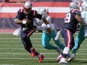 New England Patriots quarterback Cam Newton, front, runs from Miami Dolphins linebacker Kyle Van Noy (53)in the first half of an NFL football game, Sunday, Sept. 13, 2020, in Foxborough, Mass.