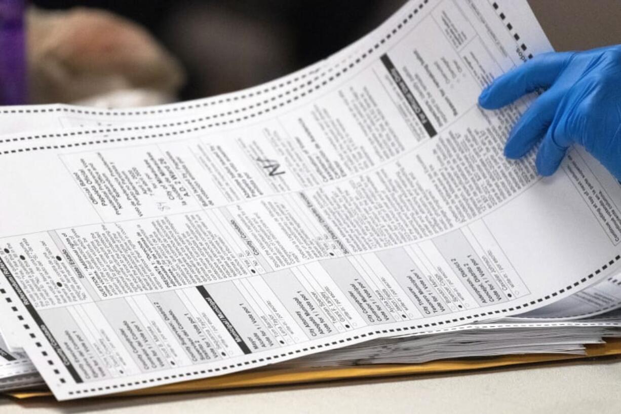 FILE - In this April 8, 2020, file photo, a City of Milwaukee Election Commission worker processes absentee ballots for the state&#039;s primary election, in downtown Milwaukee. On Tuesday, Sept. 29, 2020, a federal appeals court upheld a six-day extension for counting absentee ballots in Wisconsin. Absentee ballots are typically due at local clerks&#039; offices by 8 p.m. on Election Day. The case is likely to be appealed by Republicans to the U.S. Supreme Court.