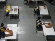 Workers prepare absentee ballots for mailing Sept. 3 at the Wake County Board of Elections in Raleigh, N.C.