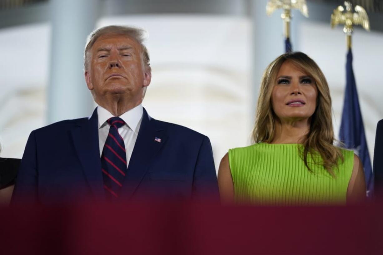 President Donald Trump and first lady Melania Trump stand on stage on the South Lawn of the White House on the fourth day of the Republican National Convention, Thursday, Aug. 27, 2020, in Washington.