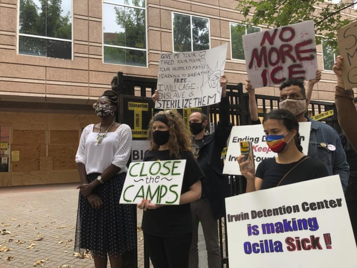 FILE - In this Tuesday, Sept. 15, 2020, file photo, Dawn Wooten, left, a nurse at Irwin County Detention Center in Ocilla, Georgia, speaks at a  news conference in Atlanta protesting conditions at the immigration jail. An Associated Press review of medical records for four detained immigrant women at the detention center and interviews with lawyers have revealed growing allegations that a gynecologist performed surgeries that the women never sought or didn&#039;t fully understand.