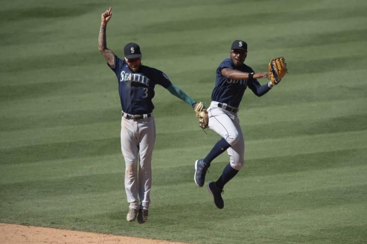 Shortstop J.P. Crawford, left, and center fielder Kyle Lewis are two of the main building blocks of a young Seattle Mariners roster. The team might not be a contender this season, but general manager Jerry Dipoto is rebuilding the roster with an eye on success in coming years.