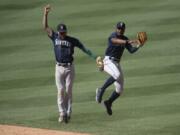 Shortstop J.P. Crawford, left, and center fielder Kyle Lewis are two of the main building blocks of a young Seattle Mariners roster. The team might not be a contender this season, but general manager Jerry Dipoto is rebuilding the roster with an eye on success in coming years.