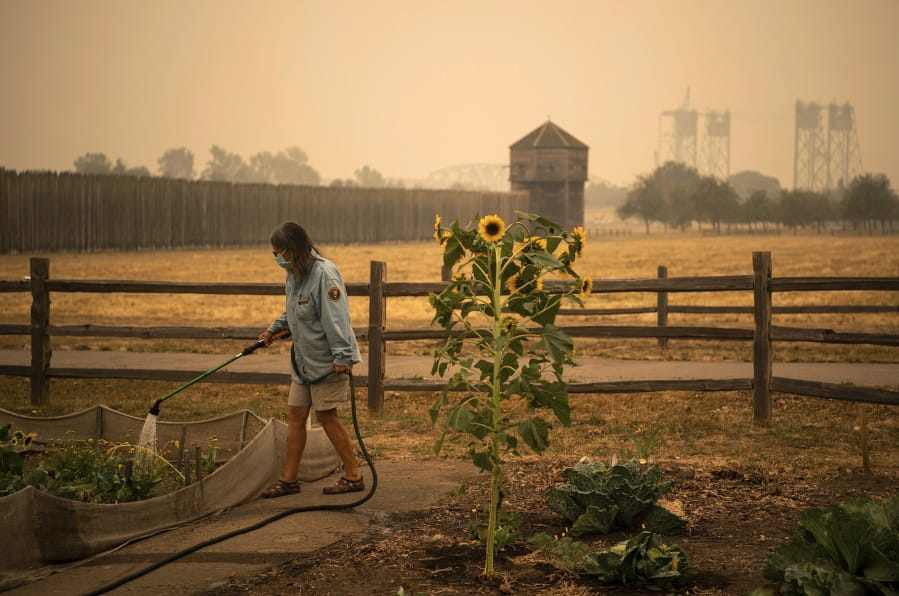 Volunteer Elizabeth Stoltz of Heisson waters the Fort Vancouver Garden in Vancouver in 2020.