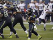 Seattle Seahawks quarterback Russell Wilson passes against the New England Patriots during the second half of an NFL football game, Sunday, Sept. 20, 2020, in Seattle.