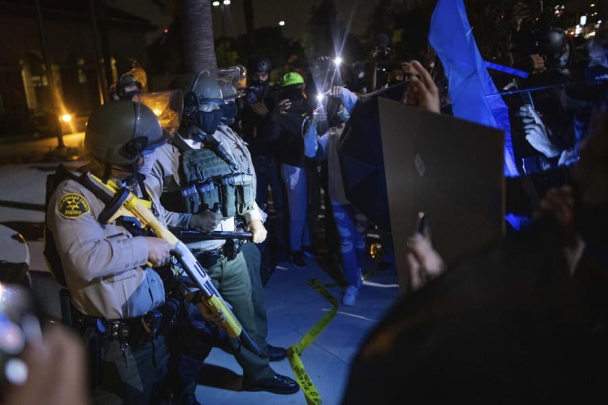 Protesters clash with deputies of the Los Angeles Sheriff&#039;s Department during protests following the death of Dijon Kizzee on Monday, Aug. 31, 2020, in Los Angeles, Calif.