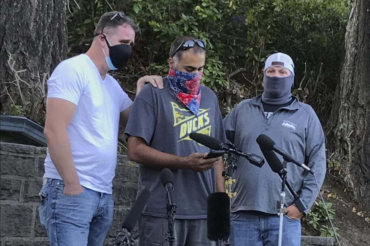 Luke Carrillo, center, speaks about Aaron Danielson at a news conference Monday, Aug. 31, 2020, in Portland, Ore. Danielson, a supporter of the right-wing Patriot Prayer group, was killed on Saturday, Aug. 29, as supporters of President Donald Trump and Black Lives Matter protesters clashed.