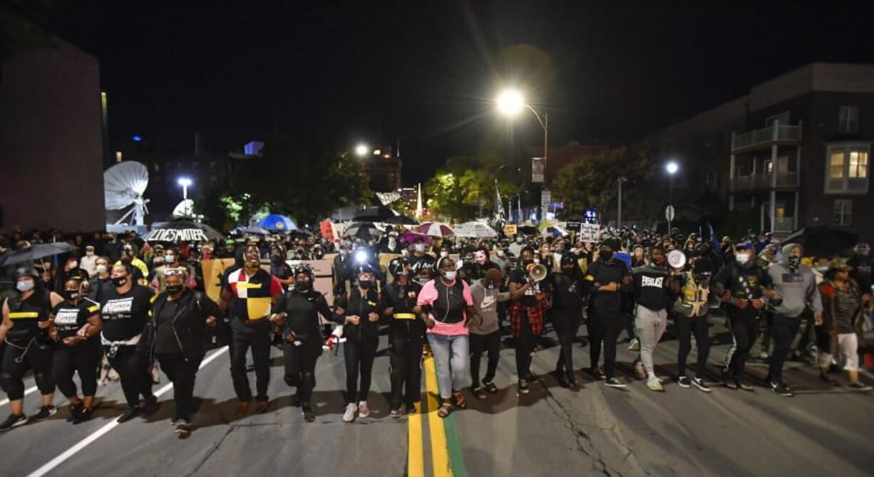 Demonstrators march through the streets in Rochester, N.Y., Friday, Sept. 4, 2020, protesting the death of Daniel Prude. Prude apparently stopped breathing as police in Rochester were restraining him in March 2020 and died when he was taken off life support a week later.