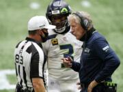 Seattle Seahawks quarterback Russell Wilson (3) and Seattle Seahawks head coach Pete Carroll speak to back judge ShawnA  Hochuli (83) during the first half of an NFL football game against the Atlanta Falcons, Sunday, Sept. 13, 2020, in Atlanta.