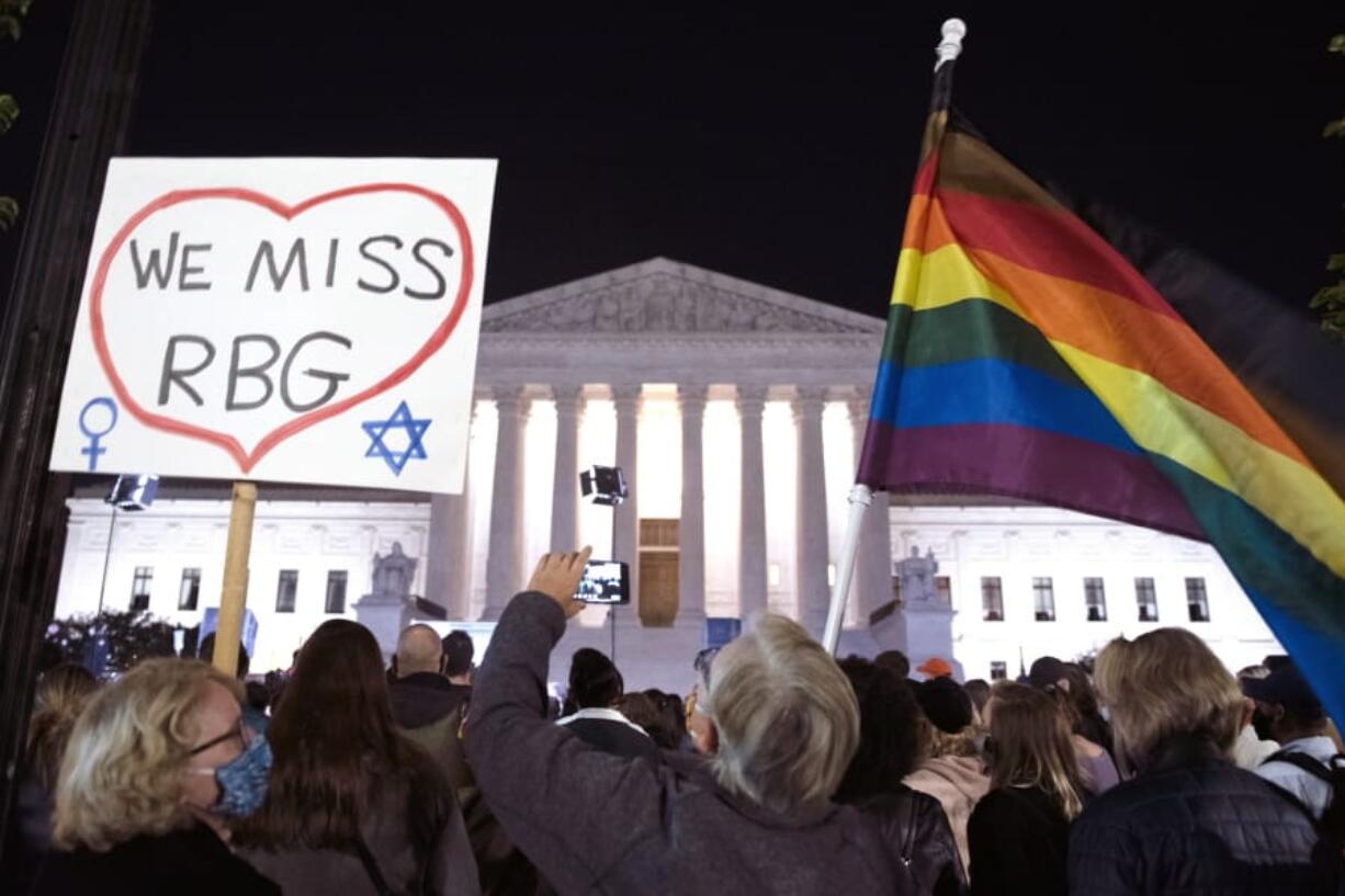 People gather at the Supreme Court to honor the late Justice Ruth Bader Ginsburg, Saturday, Sept. 19, 2020, in Washington.