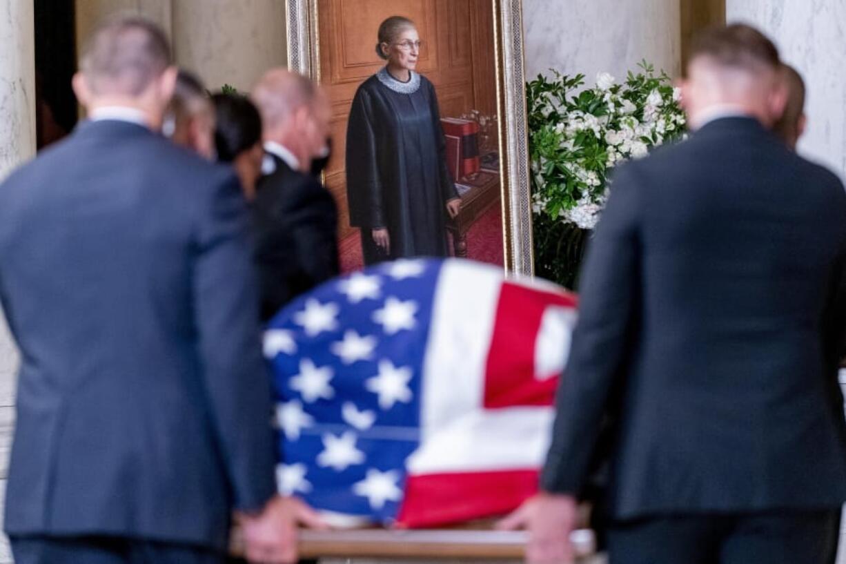 The flag-draped casket of Justice Ruth Bader Ginsburg, carried by Supreme Court police officers, arrives in the Great Hall at the Supreme Court in Washington, Wednesday, Sept. 23, 2020. Ginsburg, 87, died of cancer on Sept. 18.