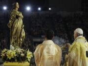 FILE - In this Nov. 21, 2019 file photo, Pope Francis blesses a statue of the Mother Mary as he celebrates Mass at the National Stadium, in Bangkok, Thailand. Pope Francis is giving his blessing to a new Vatican think tank that is seeking to prevent the Mafia and organized crime groups from exploiting the image of the Virgin Mary for their own illicit ends.