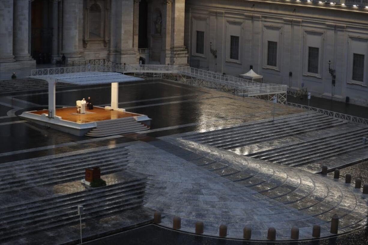 FILE - In this photo taken on March 27, 2020, Pope Francis, white figure standing alone at center, delivers an Urbi et orbi prayer from the empty St. Peter&#039;s Square, at the Vatican. If ever there was a defining moment of Pope Francis during the coronavirus pandemic, it came on March 27, the day Italy recorded its single biggest daily jump in fatalities. From the rain-slicked promenade of St. Peter&#039;s Basilica, Francis said the virus had shown that we&#039;re all in this together, that we need each other and need to reassess our priorities.