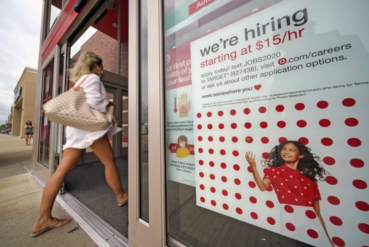 FILE - In this Sept. 2, 2020, file photo, a help wanted sign hangs on the door of a Target store in Uniontown, Pa. The government issues the jobs report Friday, Sept. 4, for August at a time of continuing layoffs and high unemployment. (AP Photo/Gene J.